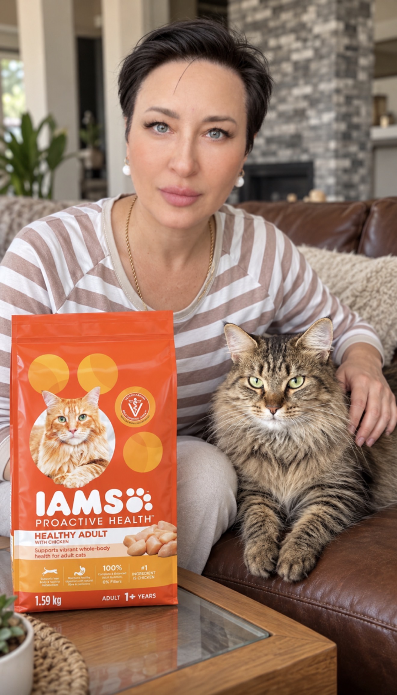 Yuliya with her cat Rozi beside an orange bag of IAMS ProActive Health Healthy Adult cat food with chicken